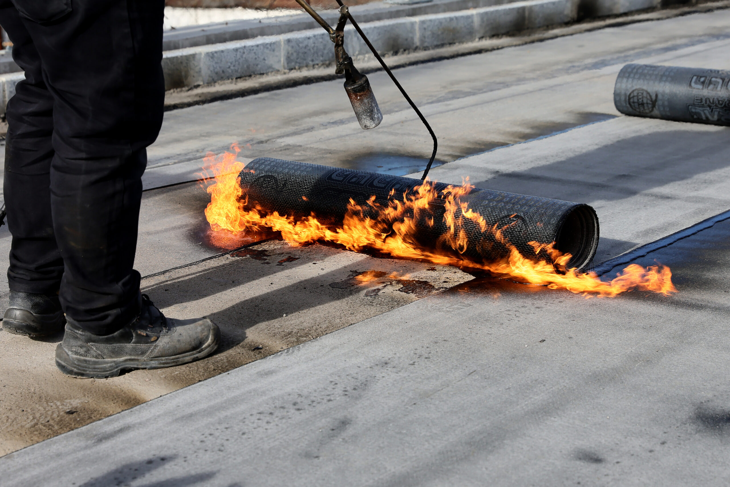 Worker Installing Commercial Modified Bitumen Roof